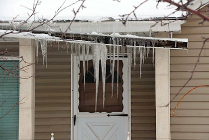 Roof gutter damaged by winter ice.