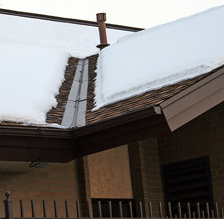 A roof de-icing system installed to heat roof valley and eaves.